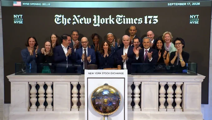 Managers of The New York Times ringing the bell at the New York Stock Exchange under a sign that says "The New York Times 175"